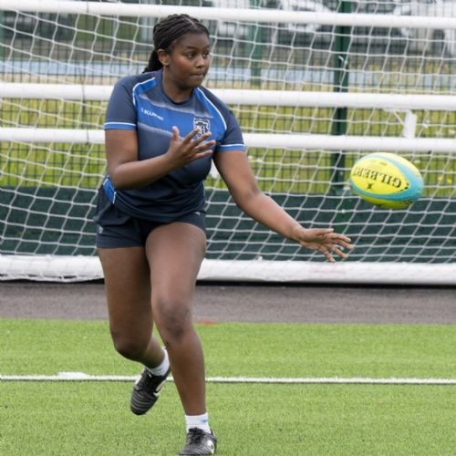 Female rugby player throwing a ball